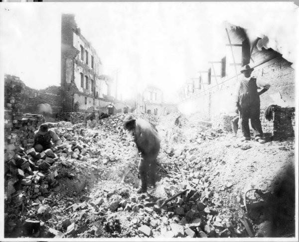 Remaining Greenwood residents sift through rubble following the riots.